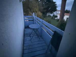 a balcony with a stool on the side of a building at Confort Famille dans Résidence avec Piscine - FR-1-778-39 in Dolus-d'Oléron