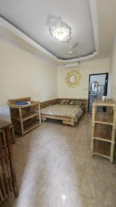 a living room with a bed and a table at Classic House By Green View in Ubud