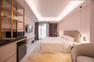 a hotel room with a bed and a tv at Wanda Jin Residences The Ease Sierra Bangkok in Ban Na Song +38 photos