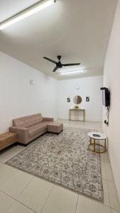 a living room with a couch and a rug at Home-Away Homestay in Gerik