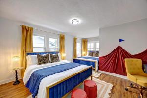 a bedroom with two beds and a red curtain at 4BR Near Lucas Oil º IUPUI º Convention Centerº DT in Indianapolis