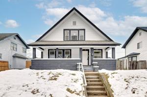 a white house with snow in front of it at 4BR Near Lucas Oil º IUPUI º Convention Centerº DT in Indianapolis