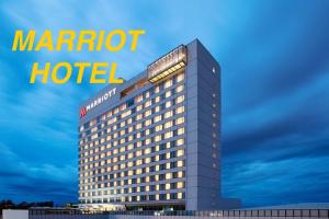 a marriott hotel with a sign on top of it at Affordable MODERN Up to 16 Pax Near Aqua Planet & Clark International Airport in Angeles