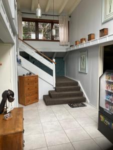 a living room with stairs and a stair case at Arden Country House BnB - Entire house to yourself -peace in the country in Dunedin