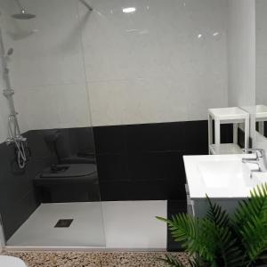 a bathroom with a sink and a toilet at María PLAYA ARENA NG in Peniscola