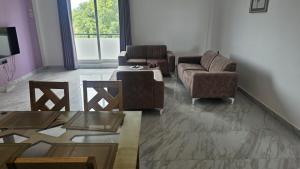 a living room with two chairs and a couch and a table at Blackpool Complex - Lavender in Trincomalee