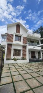 a large white house with at Reverie Homestay in Munroe Island