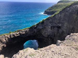 a cave on a cliff near the ocean at La Bulle de Maloma - Piscine réouverte, Cocon pour Duo, Plage à 2 min in Grand-Bourg +23 photos