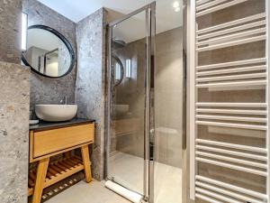 a bathroom with a glass shower and a sink at Appartement familial à Méribel avec services sur mesure - FR-1-613-130 in Les Allues +7 photos