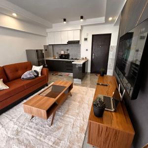 a living room with a couch and a table at Calm cozy home in Eldoret Airport