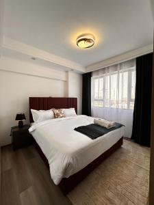 a bedroom with a large bed and a window at Calm cozy home in Eldoret Airport