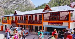 a group of people standing in front of a building at Hotel Chandra Lok Cottage Kabra Niketan in Gangotri