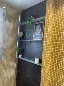 a bathroom with a sign on a tiled wall at Bonito apartamento en Aguadulce in Aguadulce +21 photos