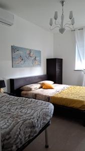 a bedroom with two beds and a painting on the wall at Malnati home in Terni