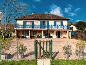 a large house with a fence in front of it at Le Petit Bouleau in Saint-Pardoux-la-Rivière
