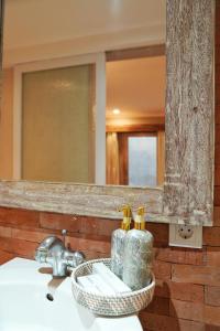 a bathroom with a sink with a mirror and a sink at Koura Jimbaran in Badung