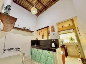 a kitchen with a green cabinet and a sink at Harbor View AC Apartment in Ambalangoda +8 photos