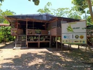 a building with a sign in front of it at Estación Biológica Santa María de Fátima II Zona in Iquitos