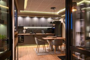 a kitchen with a table and chairs in a room at All Seasons Apartment in Sofia