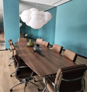 a conference room with a large wooden table and chairs at Apartment with city views central area in Guadalajara