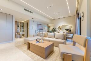 a living room with a couch and a table at Sea and Palm Jumeirah Views Just Steps from the Beach 2BR, Sadaf 6 , JBR by Deluxe Holiday Homes in Dubai