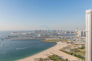 an aerial view of a beach and a city at Sea and Palm Jumeirah Views Just Steps from the Beach 2BR, Sadaf 6 , JBR by Deluxe Holiday Homes in Dubai