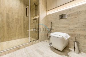 a bathroom with a toilet and a shower at Sea and Palm Jumeirah Views Just Steps from the Beach 2BR, Sadaf 6 , JBR by Deluxe Holiday Homes in Dubai