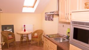 a kitchen with a sink and a table with chairs at Studio VS 14 in Heringsdorf