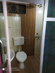 a small bathroom with a toilet and a sink at Hotel Maya Residency in Jaipur