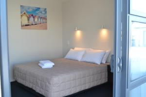 a bedroom with a bed with two towels on it at 319 Addington Motel in Christchurch