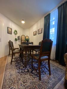 a dining room with a wooden table and two chairs at Schloss Nidda - FeWo mit Privatgarten, Fellnasen willkommen! in Nidda