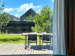 a table and chairs sitting on a patio at Laimingi namai in Palanga