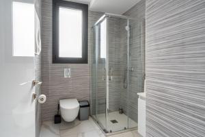 een badkamer met toilet en glazen douche bij Dusk - Harmonic Studio by Plus 49 in Mackenzie in Larnaka +12 foto's