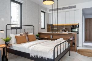een slaapkamer met een groot bed en een keuken bij Dusk - Harmonic Studio by Plus 49 in Mackenzie in Larnaka