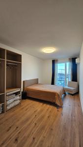 a bedroom with a large bed and a wooden floor at Cozy Urban Heaven with Dedicated Parking Spot in Sofia +54 photos