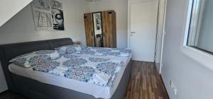 a bedroom with a bed with a quilt on it at Vienna Airport Residences in Himberg