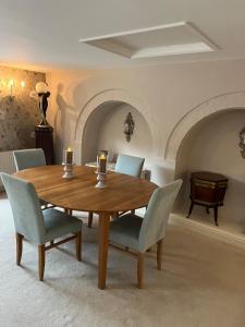 a dining room with a wooden table and chairs at Boutique village property in Broughton +7 photos