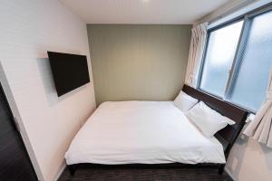 Postel nebo postele na pokoji v ubytování GLOU Higashi Shinjuku