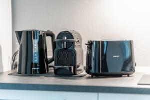 a counter with several appliances on a counter top at My little house in Milan
