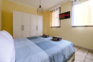 a bedroom with a bed with two bags on it at My little house in Milan
