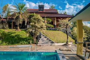 a house with a swimming pool in front of a house at Villa Dua Sisi RedPartner in Paragajen