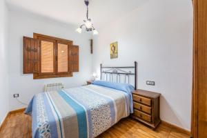 a bedroom with a bed and a dresser and a window at Casa Rural La Jirola -Vivienda 2 in Escúllar +20 photos