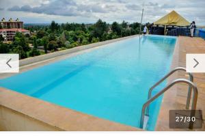 a large swimming pool on top of a building at Residence Next Door Coral Mega in Kiambu