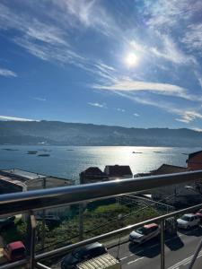 a view of a body of water with cars parked at Ático playa Palmás in Moaña