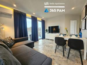 a living room with a couch and a table at 365PAM - Apartament Bliżej Morza w Gąskach in Gąski