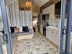 a living room with a couch and a kitchen at Blairgowrie Holiday Park in Blairgowrie