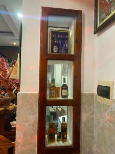 a display case with bottles of whiskey in a store at Cát Tường Hotel in Lagi