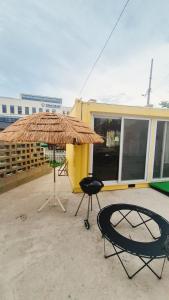 een patio met een parasol, een stoel en een tafel bij Yangyang Shim Stay in Yangyang +12 foto's