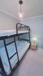 een slaapkamer met twee stapelbedden en een lamp bij Yangyang Shim Stay in Yangyang