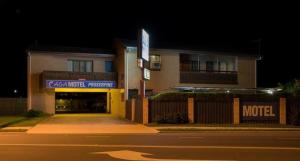 a building with a motel sign in front of a street at A & A Motel in Proserpine